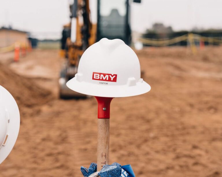 BMY-construction-hat-on-top-of-a-shovel-stuck-in-the-ground-in-a-ceremonial-fashion