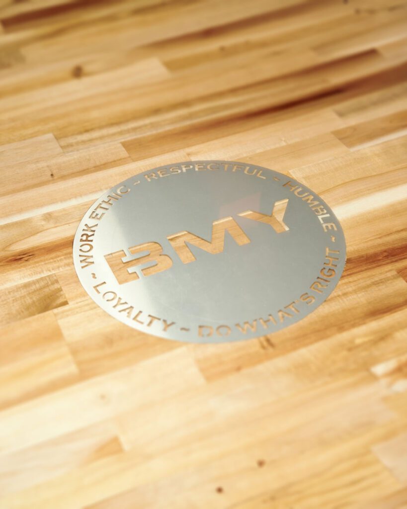 BMY-seal-on-a-wooden-tabletop
